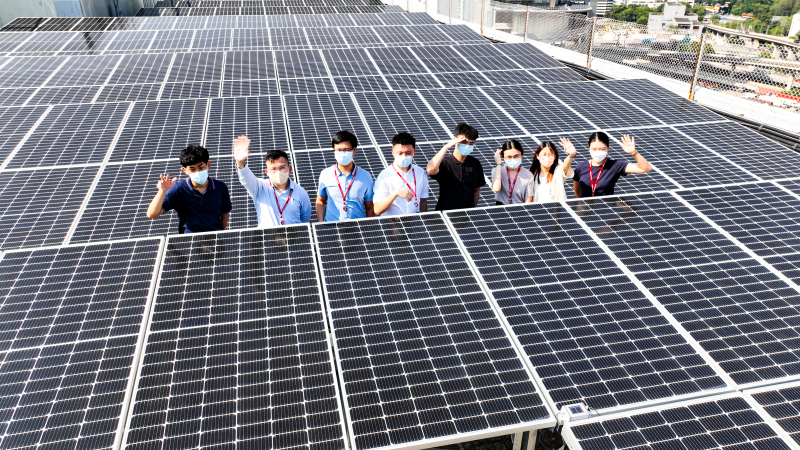 Summer interns with solar panels
